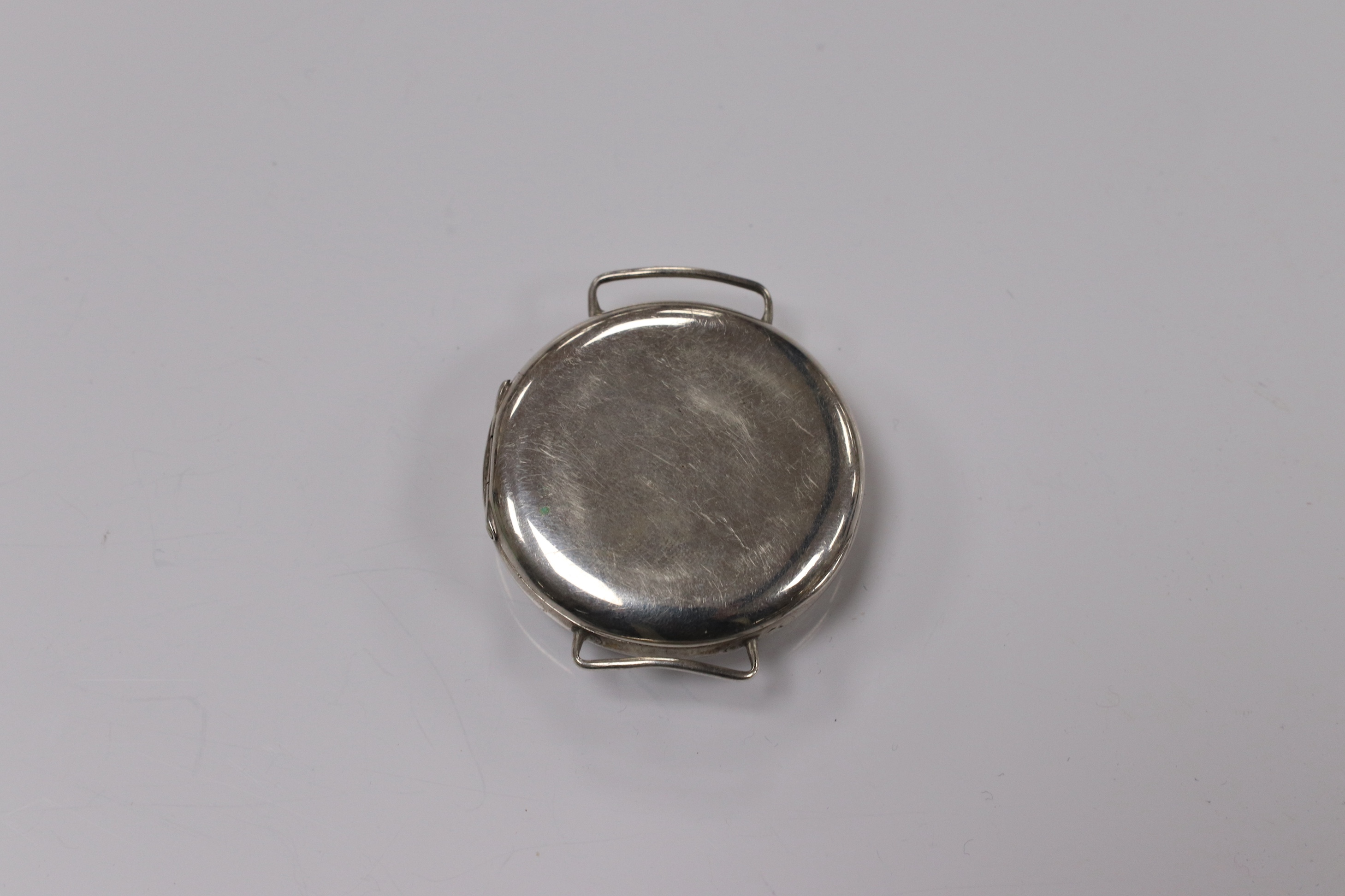 A George V silver manual wind trench watch with 'telephone dial' shrapnel guard, case import marked for London, 1917, case diameter 35mm, lacking winding crown. No strap. Condition - poor